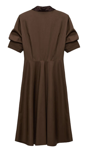 The Dorothee Schumacher Poplin Power Short Sleeve Dress features a brown cotton-poplin fabric, knee-length cut, short sleeves, a fitted waist, and a subtly flared skirt, displayed on a plain white background.