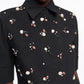 A person wears the Dorothee Schumacher Poplin Power Embellished Blouse, a black cotton-poplin shirt featuring clusters of pearl and brown bead details.