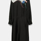 The Seductive Bloom Maxi Dress by Dorothee Schumacher is a long-sleeved black silk shirtdress with a white upper, multicolored floral embroidery, and a stylish wrap-around tie collar, showcased on a plain background.