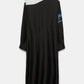 The Seductive Bloom Maxi Dress by Dorothee Schumacher is a long-sleeve silk shirtdress with a white top, black skirt, blue floral sleeve accents, and a wrap tie collar, showcased from the back.