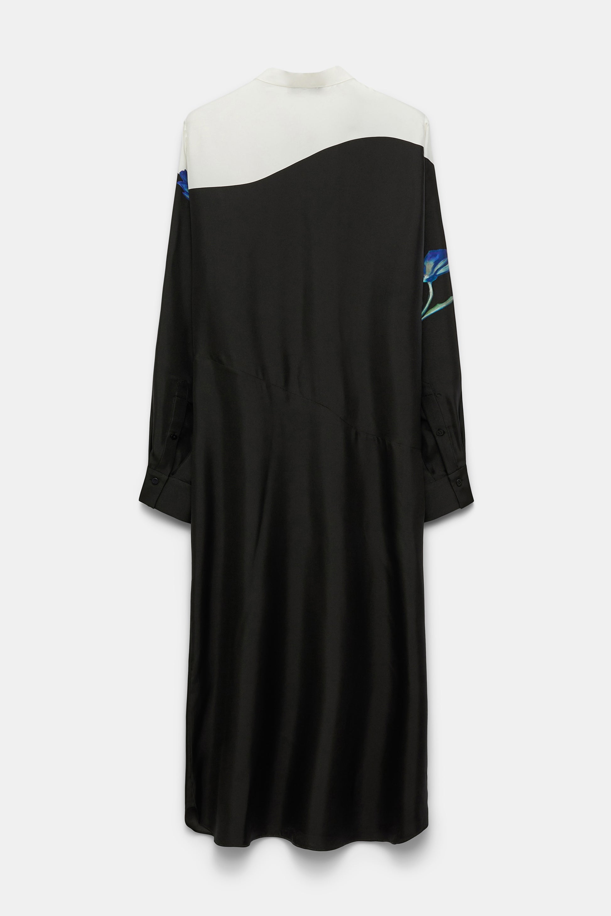 The Seductive Bloom Maxi Dress by Dorothee Schumacher is a long-sleeve silk shirtdress with a white top, black skirt, blue floral sleeve accents, and a wrap tie collar, showcased from the back.