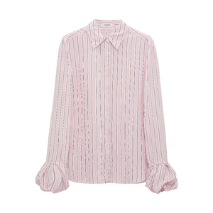 The Striped Ease Blouse by Dorothee Schumacher features light pink organdy voile with vertical black and white stripes, a pointed collar, and ruffled balloon cuffs, shown on a plain white background.