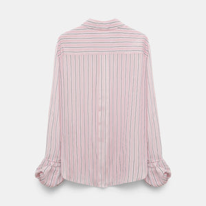 The Striped Ease Blouse by Dorothee Schumacher features vertical pink and white stripes, balloon cuffs, and long sleeves, shown from the back against a plain white background.