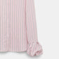 Close-up of the Striped Ease Blouse by Dorothee Schumacher, crafted in pink and white organdy voile with elegant balloon cuffs and ruffled details.