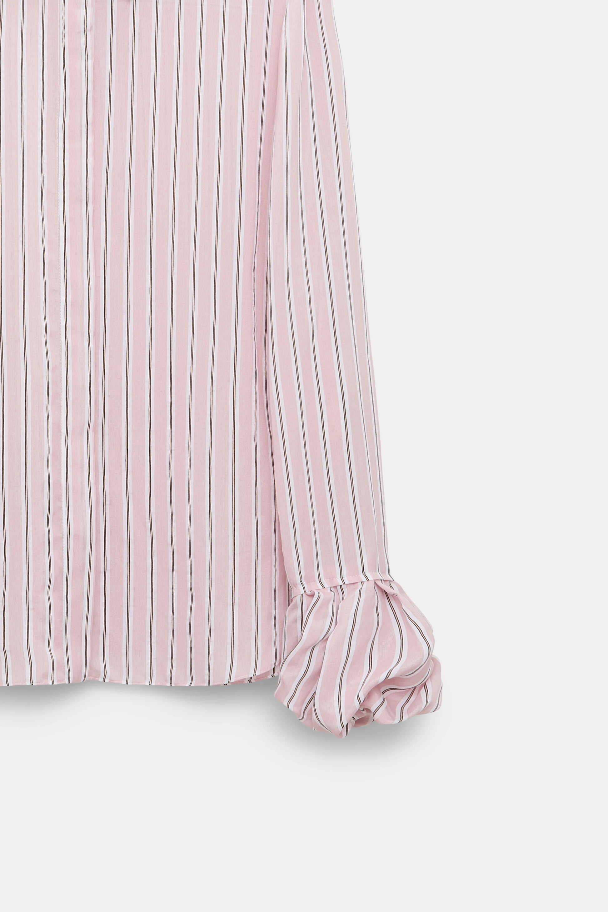 Close-up of the Striped Ease Blouse by Dorothee Schumacher, crafted in pink and white organdy voile with elegant balloon cuffs and ruffled details.