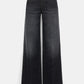 The Deep Love Pants by Dorothee Schumacher are dark wash, mid-rise wide-leg jeans with front and back pockets and a button-zip closure, shown on a plain white background.
