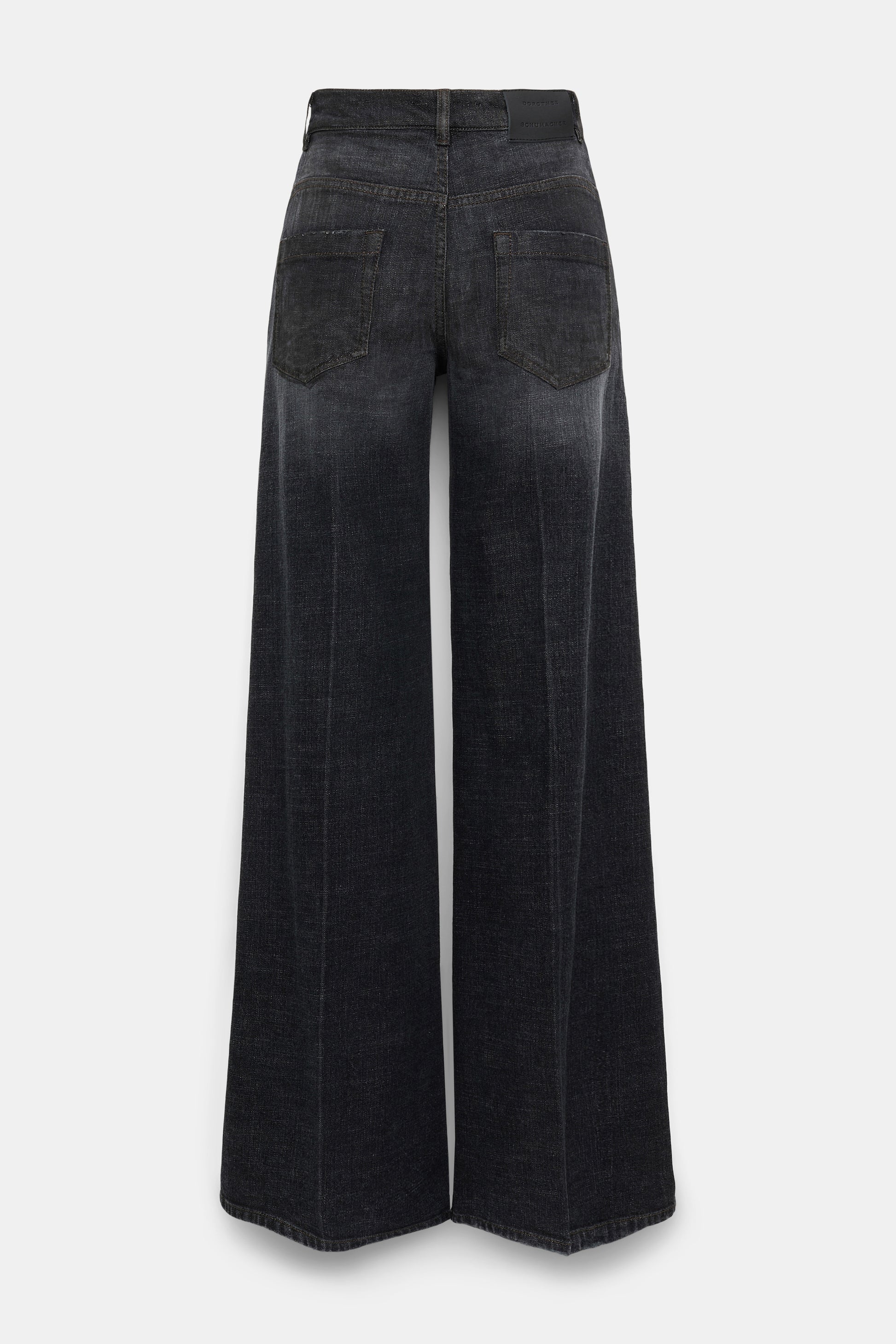 Back view of Dorothee Schumacher's Deep Love Pants—wide-leg, dark wash black denim jeans with two back pockets and a waistband featuring a black label.