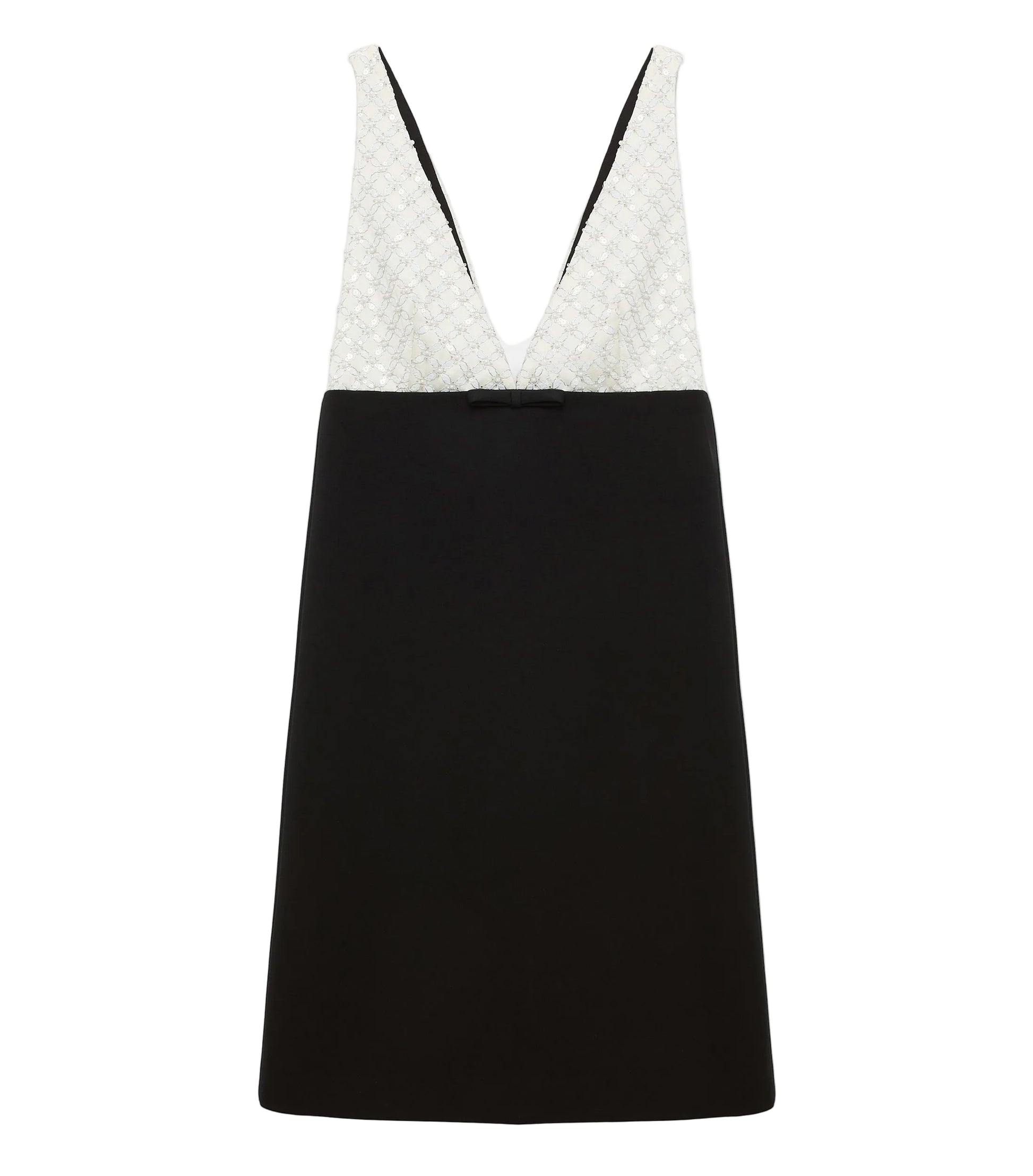 The Emotional Essence Dress by Dorothee Schumacher features a sleeveless V-neck, a white textured bodice, solid black skirt, and a small black bow at the waist.