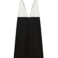 The Emotional Essence Dress by Dorothee Schumacher is a sleeveless Punto Milano style with a deep V neckline, featuring a white textured top and solid black bottom.