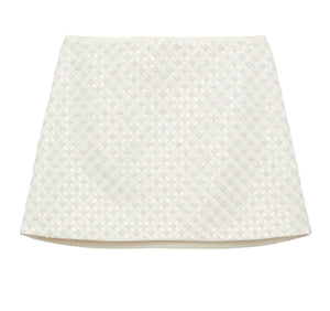 The Dorothee Schumacher Sparkling Statement Mini Skirt is a white A-line piece with a textured geometric lace pattern on the front, offering a fresh, modern look.
