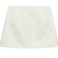 Dorothee Schumacher's Sparkling Statement Mini Skirt showcases an A-line silhouette with a quilted geometric pattern and subtle metallic details, displayed on a plain white background.