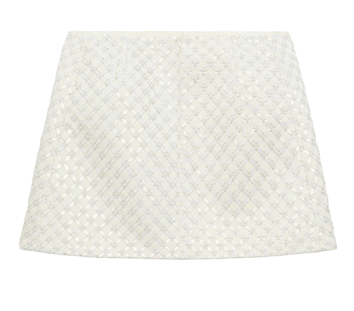 Dorothee Schumacher's Sparkling Statement Mini Skirt showcases an A-line silhouette with a quilted geometric pattern and subtle metallic details, displayed on a plain white background.