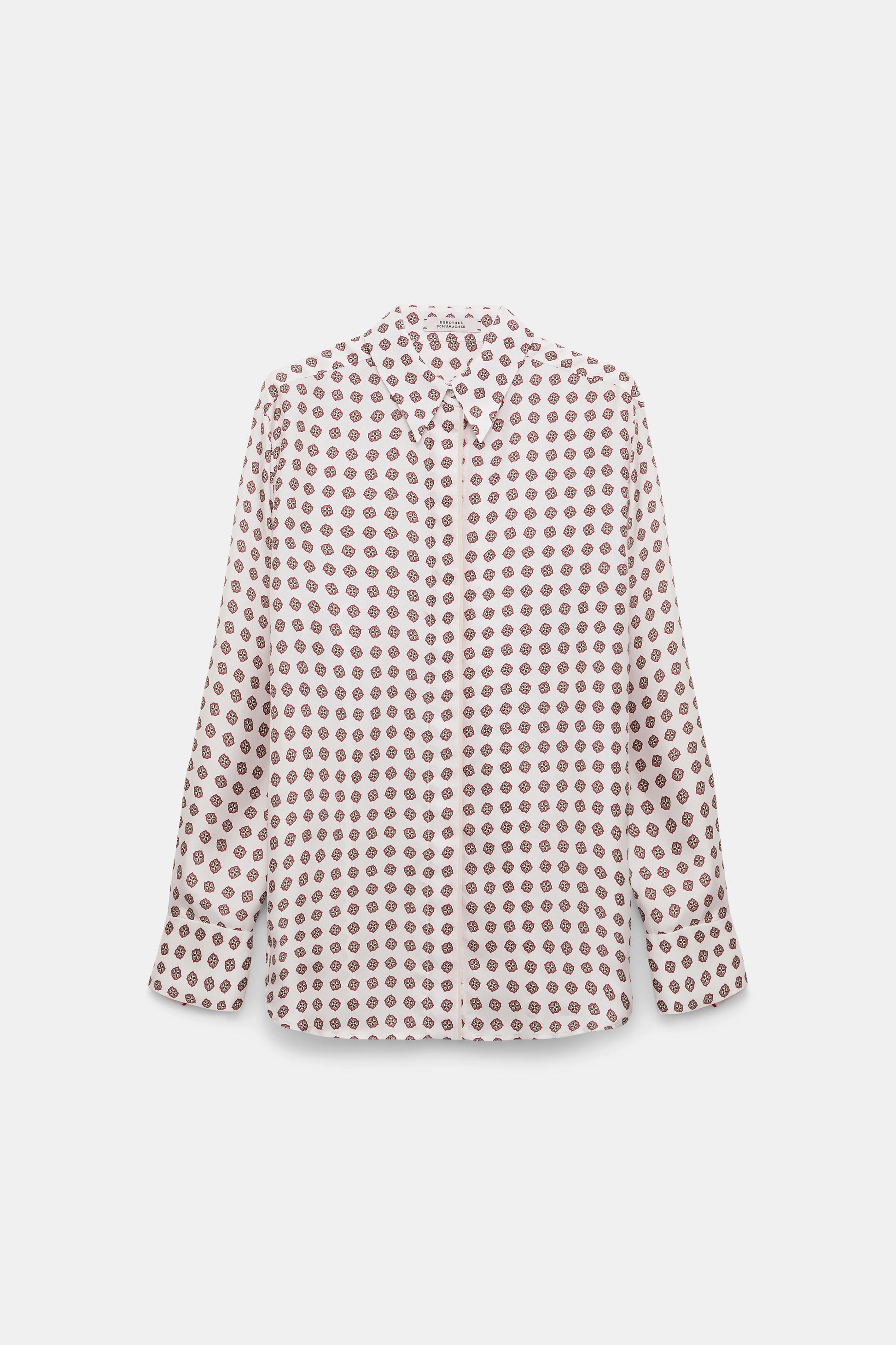 The Dorothee Schumacher Graphic Dreams Blouse is a white, long-sleeve silk twill shirt featuring small brown geometric motifs inspired by the brand’s signature tie print, shown on a plain white background.