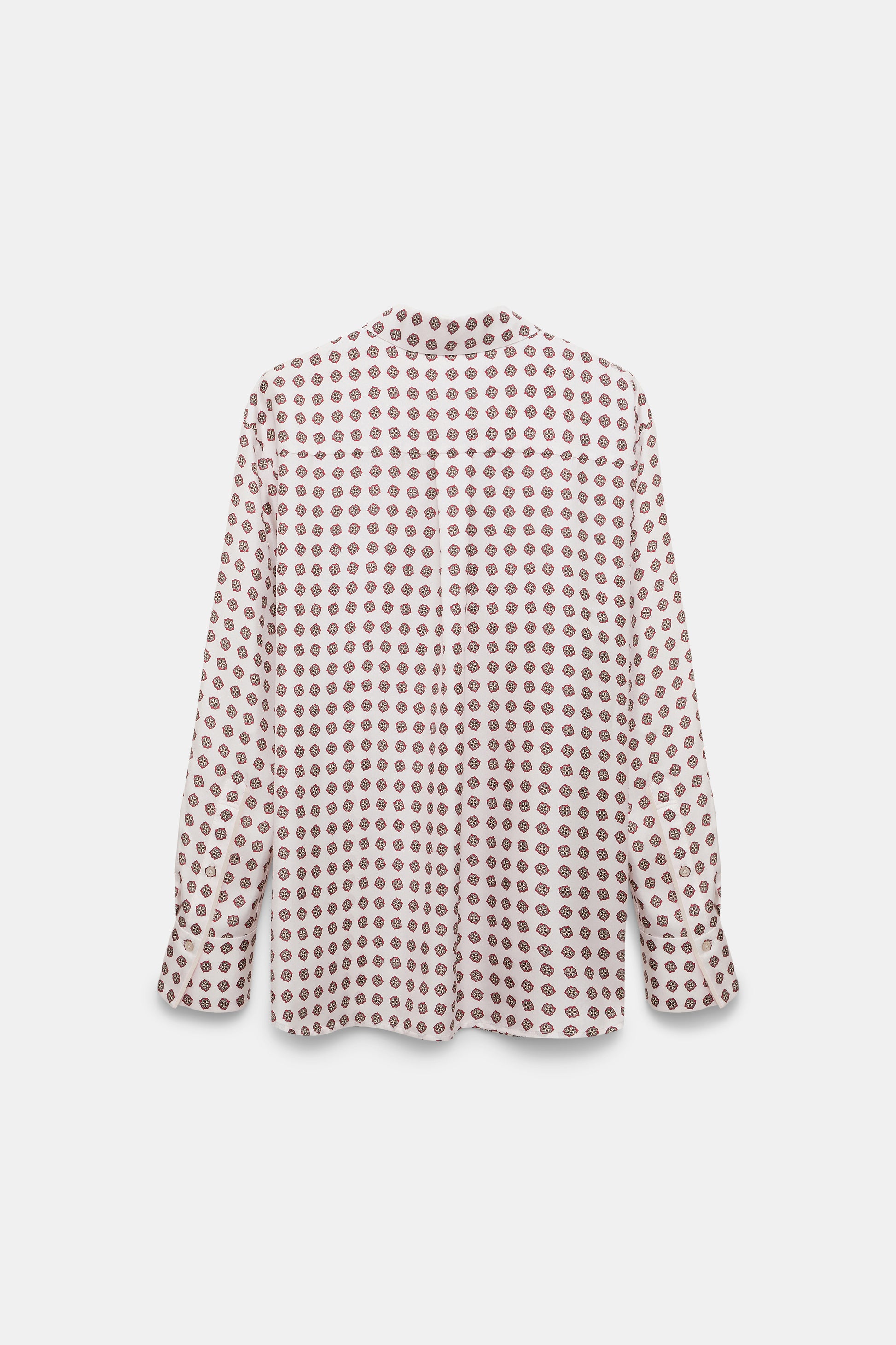 The Dorothee Schumacher Graphic Dreams Blouse is a relaxed fit, long-sleeve button-up with an all-over red circular print on white, shown on a plain background.