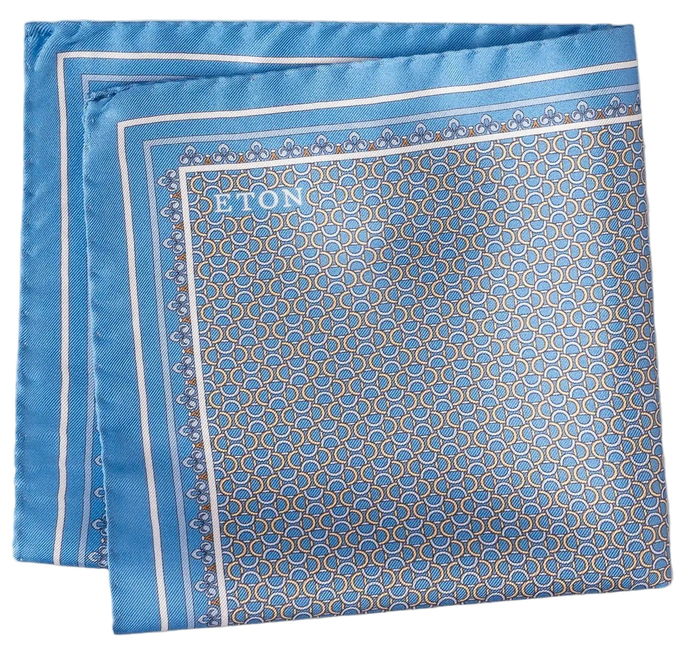 The Eton Geometric Silk Twill Pocket Square is expertly crafted from Italian printed silk and features a blue design with a small repeating hexagonal pattern, a lighter blue border, and the Eton brand name in one corner—providing a refined finishing touch.