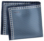 A folded Geometric Silk Twill Pocket Square by Eton, featuring a sophisticated blue hexagonal pattern and a discreet "Eton" logo in one corner, Italian printed for an elegant finish.