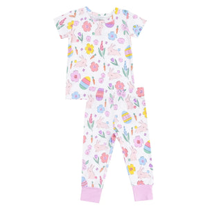 The Angel Dear Easter Bunnies Short Sleeve Loungewear Set features a white base with colorful flower, bunny, and egg prints. This super soft set includes a short-sleeve top and long pants with pink cuffs—ideal for cozy evenings.