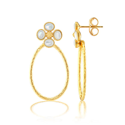 The Berry Clover Teardrop Earrings by Juliska Capucine De Wulf feature hammered gold teardrop hoops accented with a four-pearl clover design at the top, shown from front and side on a white background.