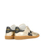 The Isabel Marant Kaycee Sneaker showcases light gold metallic leather with black details and gum soles, all set against a pristine white background.