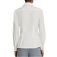 Back view of a person wearing an Emporio Sirenuse Carolina Palm Embroidery Top with tonal palm leaf details and gray pants, adding a subtle feminine touch.