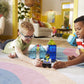 Two children play in a bright living room, building with the Magna-Tiles Police Station 20-Piece Set and racing the included toy police car on a colorful rug.