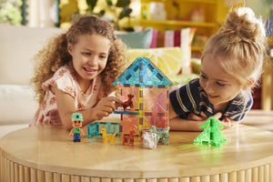 Two children enjoy imaginative play with the colorful Magnatiles Puppy Park 27-Piece Set and small animal figures on a wooden table in a brightly lit room.