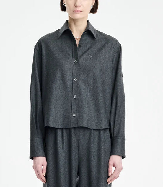 A person wearing the Maria McManus Button Sleeve Crop Shirt in dark gray wool flannel with matching pants, standing against a plain light background.