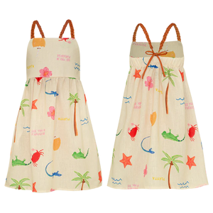 The Pepita & Me Girls' Isleno Dress is a comfy sleeveless summer dress with straps and braided shoulders, featuring a tropical print with palm trees, flowers, lizards, and starfish on a light background. Front and back views shown.