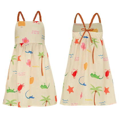 The Pepita & Me Girls' Isleno Dress is a comfy sleeveless summer dress with straps and braided shoulders, featuring a tropical print with palm trees, flowers, lizards, and starfish on a light background. Front and back views shown.