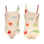The Pepita & Me Girls' Marea One Piece features braided straps and tropical prints—starfish, crab, palm tree, and iguana—in green, orange, and red on a cream background. Perfect for summer adventures!.