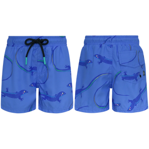 Front and back views of Pepita & Me Baby Boys' and Boys' Lobito Isleño Swim Trunks in blue, featuring a playful lizard print, black drawstring, back pocket with button closure, and quick-dry fabric for comfy swims.