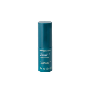 A teal bottle labeled "Barberino's Volumizing Powder" for fine hair, texturizing and reshaping, net wt. 6g.