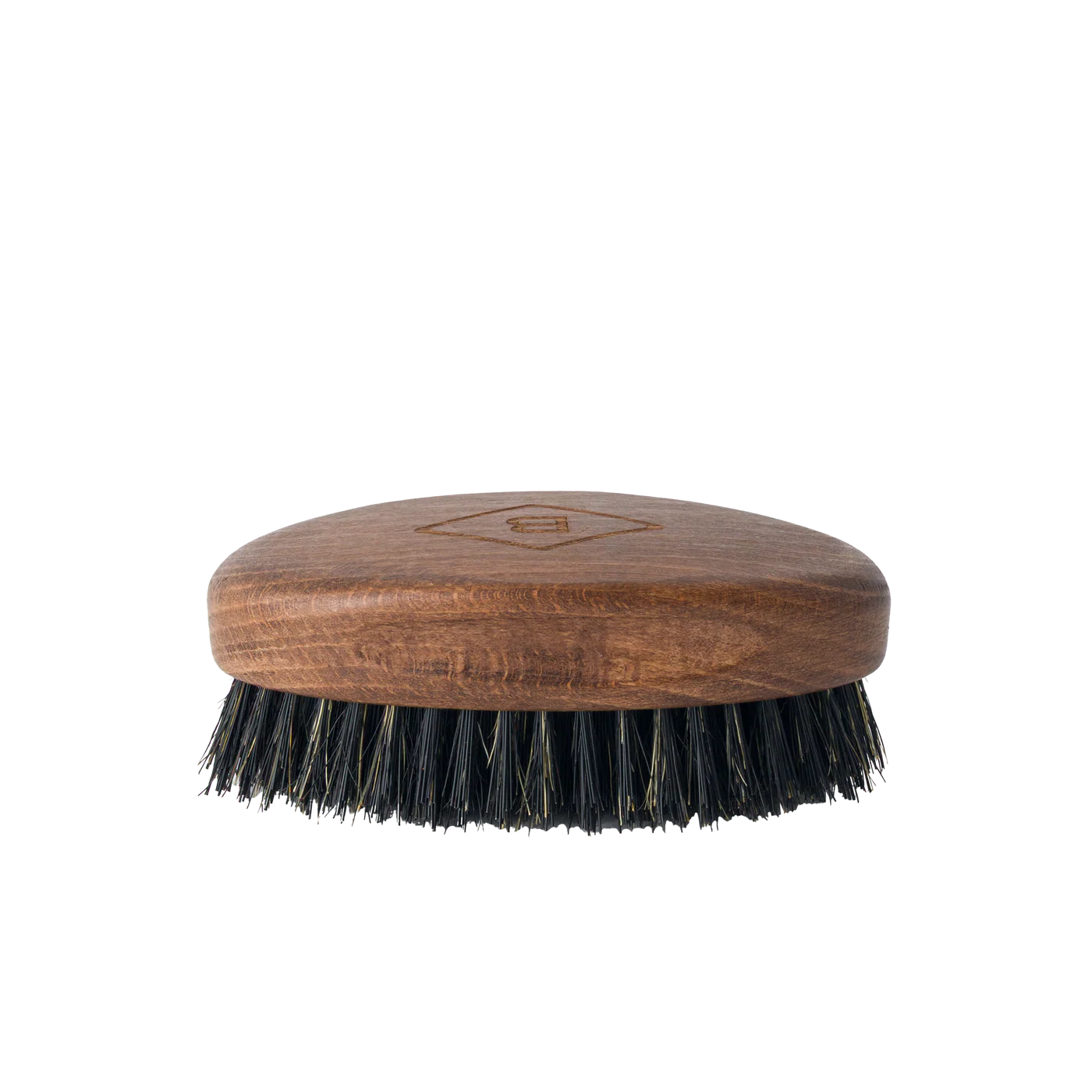 The Barberino's Beard Brush is a small oval brush with a wooden handle and dark natural bristles, ideal for grooming your beard. Shown against a plain white background.