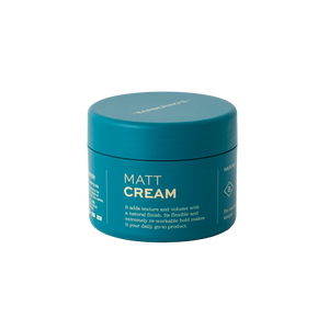 A teal container labeled "Matt Cream" by Barberino's for hair, featuring anti-frizz benefits, added texture and volume, and a reworkable medium hold.