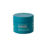 A teal jar of BRB Classic Pomade by Barberino's with white and orange text, featuring medium hold for gentlemen's grooming, is shown against a plain white background.
