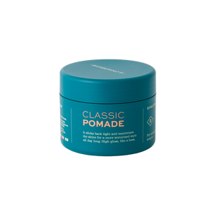 A teal jar of BRB Classic Pomade by Barberino's with white and orange text, featuring medium hold for gentlemen's grooming, is shown against a plain white background.