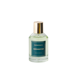A clear glass bottle of Barberino’s Agrigentum Perfume Cologne, featuring a gold cap and green label, is displayed against a plain white background.