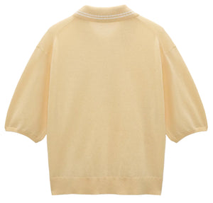 The Refined Essentials Pullover by Dorothee Schumacher is a light yellow short-sleeve stretch cotton sweater featuring ribbed collar, cuffs, and hem, shown flat with the back facing forward.