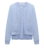 The Dorothee Schumacher Sheer Summer Twinset is a light blue, stretch cotton long-sleeve cardigan with front buttons and two patch pockets, shown on a plain white background.