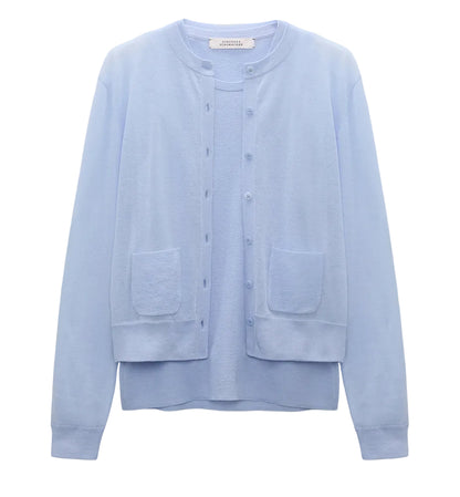 The Dorothee Schumacher Sheer Summer Twinset is a light blue, stretch cotton long-sleeve cardigan with front buttons and two patch pockets, shown on a plain white background.