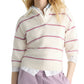 A person models the Dorothee Schumacher Sporty Statements Pullover—a cream Merino-cashmere knit with red and blue stripes—layered over a white collared shirt and paired with light purple pants, set against a white background.