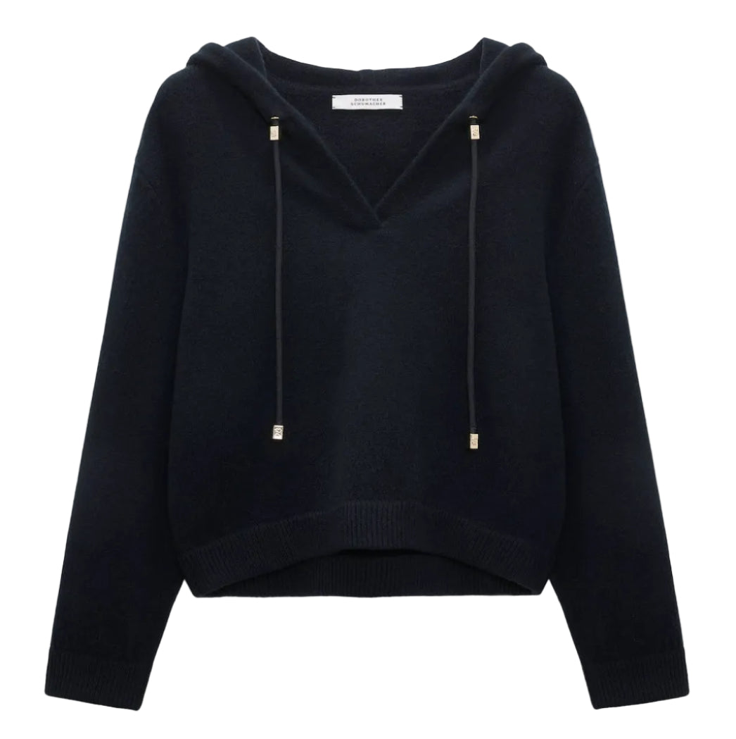 The Dorothee Schumacher Modern Statements Pullover is a black, long-sleeve cropped hoodie with a V-neck, metallic-tipped drawstrings, and a boxy fit for contemporary comfort.