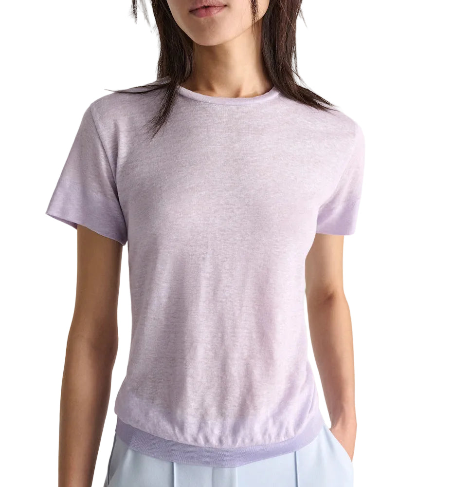 A person wears the Dorothee Schumacher Natural Ease Shirt in light purple heather with tonal knit trim and light blue pants, shown from shoulders to hips against a plain background.
