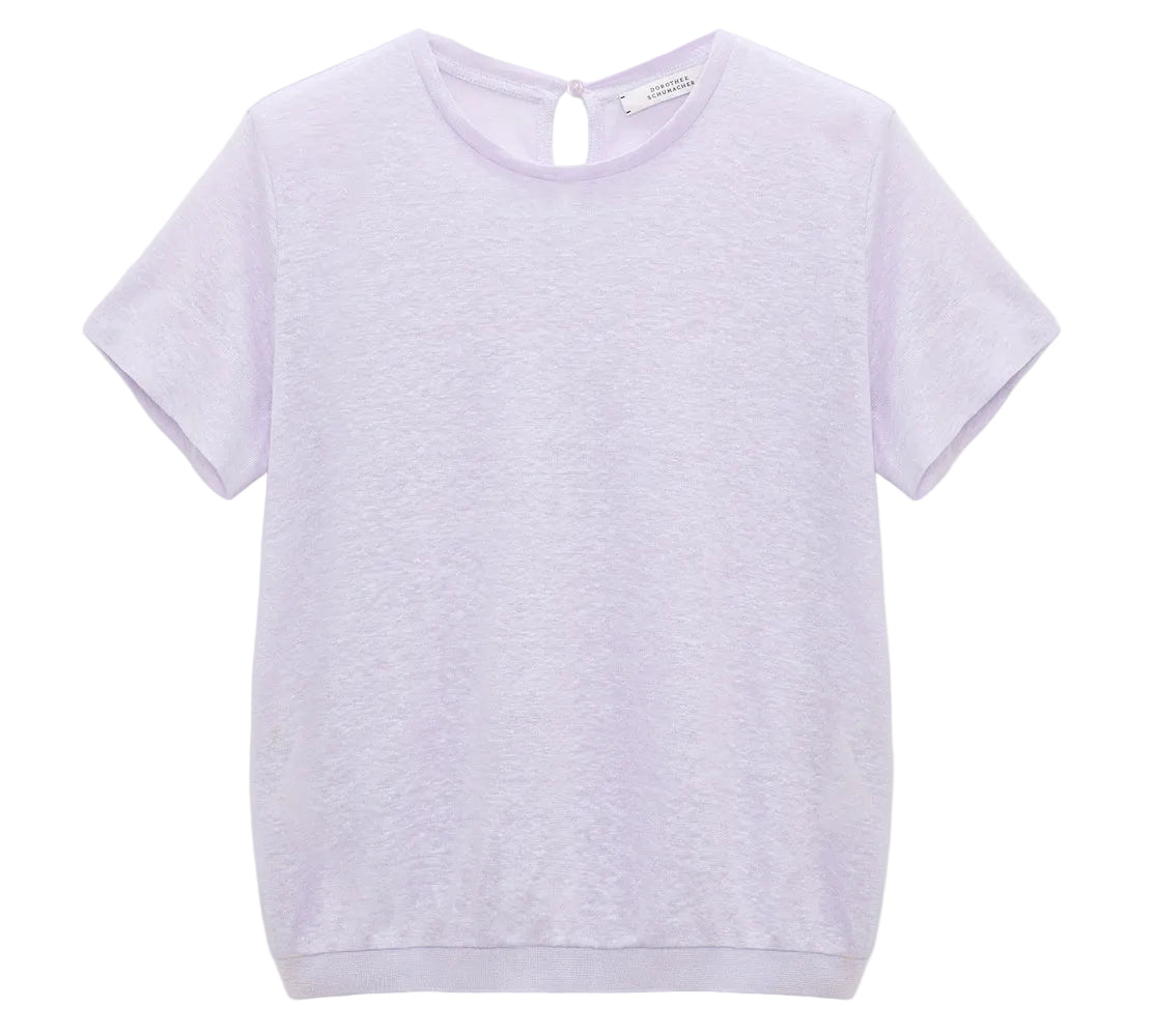 The Dorothee Schumacher Natural Ease Shirt is a plain light purple heathered top with short sleeves, a round neckline, tonal knit trim, and a small back keyhole button closure.