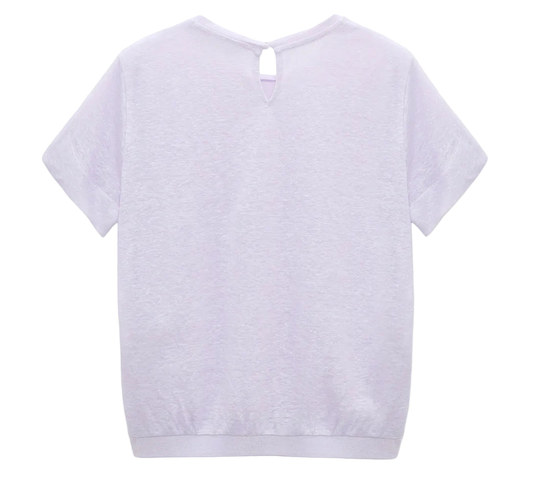 Back view of the Dorothee Schumacher Natural Ease Shirt, a plain white hemp T-shirt featuring a small buttoned keyhole near the neckline and tonal knit trim for subtle detail.