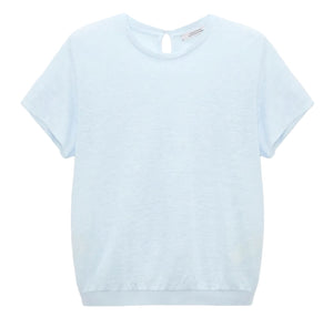 The Natural Ease Shirt by Dorothee Schumacher is a light blue heathered top with short sleeves, a crew neck, and a small buttoned keyhole at the back neckline, shown against a plain white background.