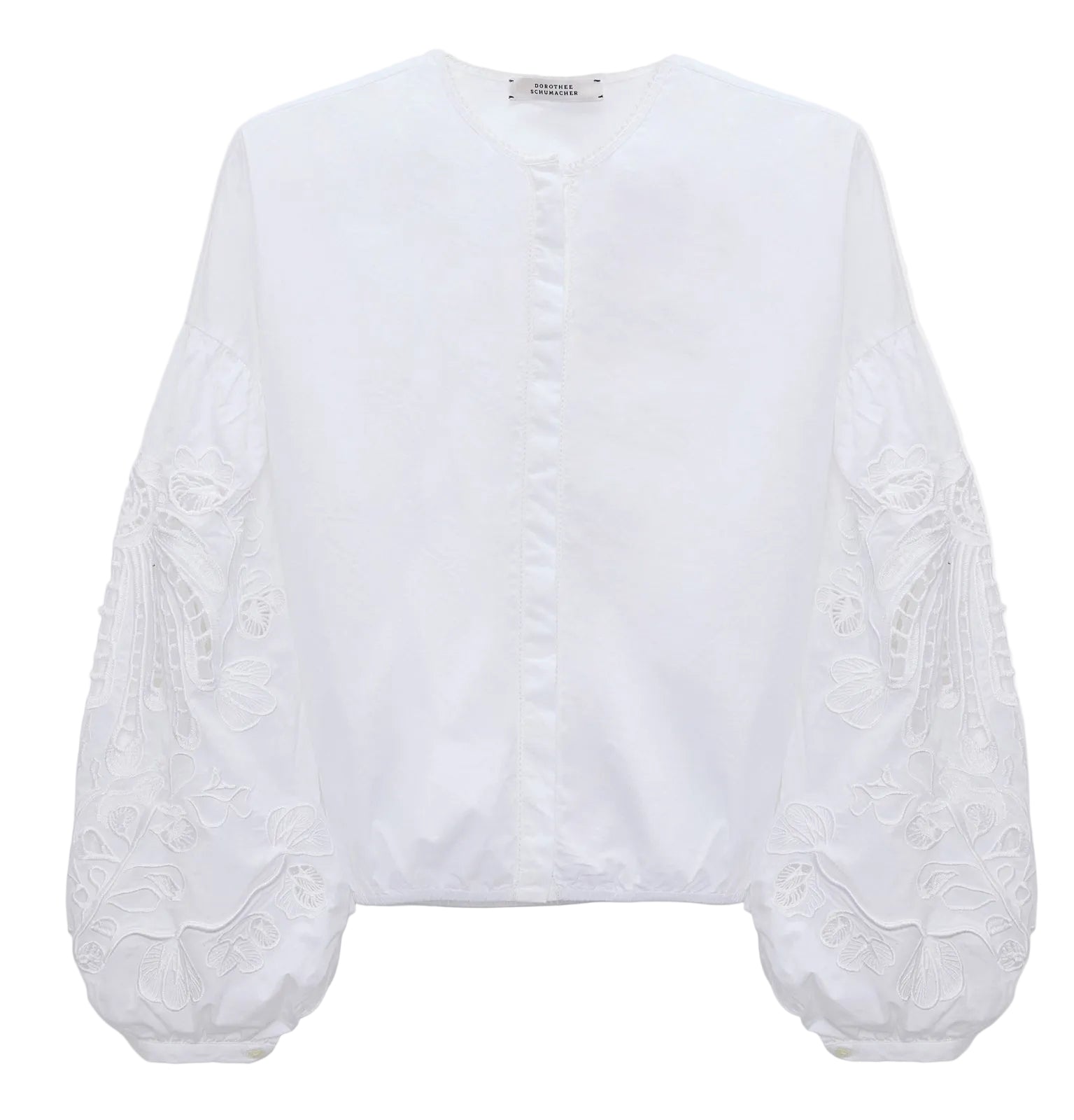 The Embroidered Beauty Blouse by Dorothee Schumacher is a white cotton top with a round neckline, long balloon sleeves, and detailed floral embroidery.