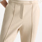 A person wearing Dorothee Schumacher Emotional Essence Pants, featuring a white color and cropped fitted design.