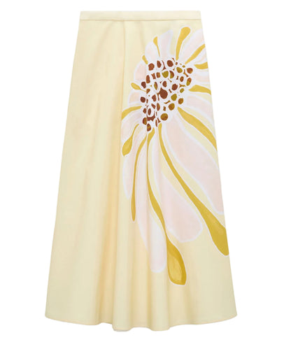 The Floral Power Skirt by Dorothee Schumacher is a cream cotton poplin midi-skirt with a fitted waist, featuring a bold abstract floral signature print in yellow, white, and brown on one side.
