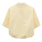 Back view of the Floral Power Blouse by Dorothee Schumacher in light yellow cotton poplin, featuring three-quarter sleeves, a loose fit, subtle upper collar embroidery, and a detachable lace collar for versatile styling.